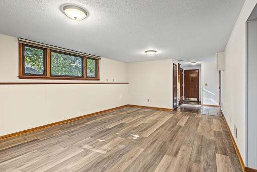 Entry area off the garage has newer tile flooring and multiple closets.