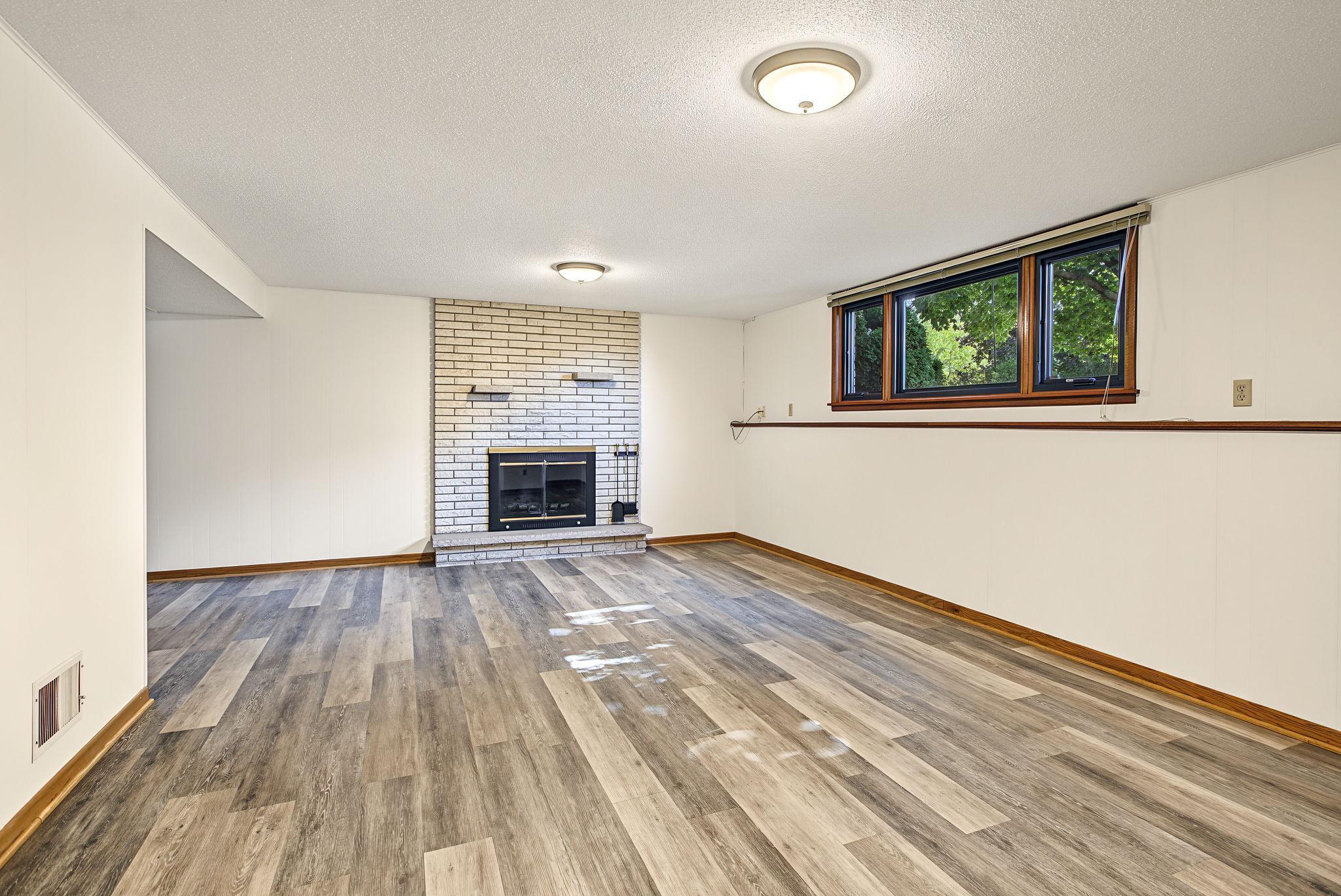 Lower level fireplace is wood burning.