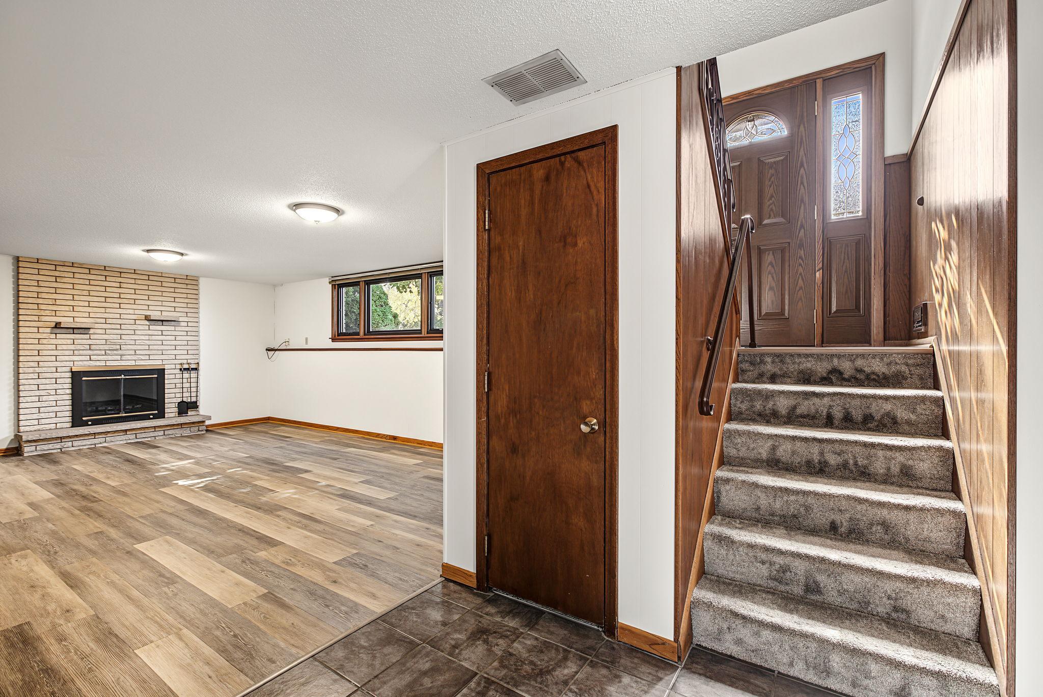 Downstairs is a large and light filled family room with updated luxury vinyl plank flooring.
