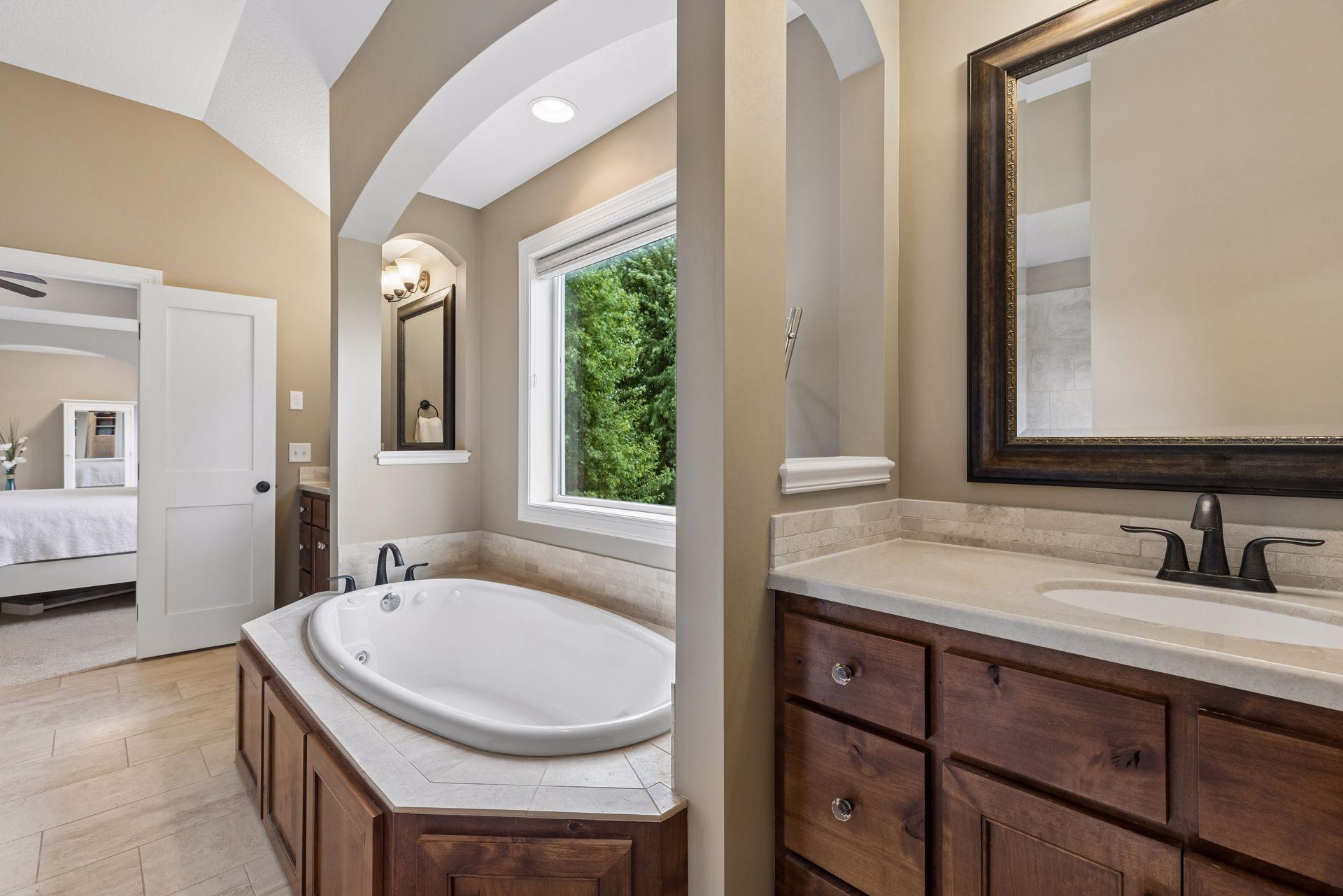 Owner's bath with soaking tub and dual vanities