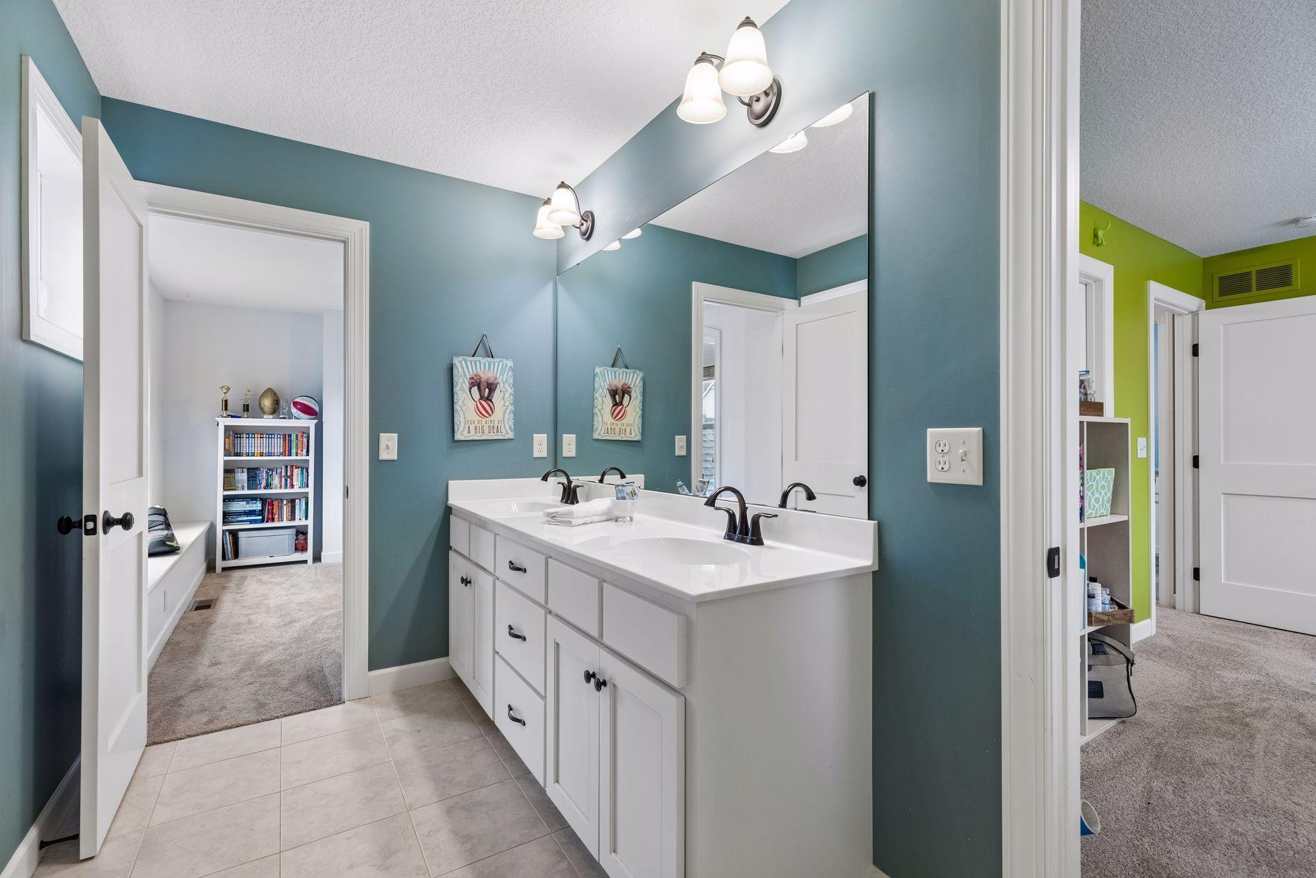 Jack and Jill bath with dual vanities and private full bath