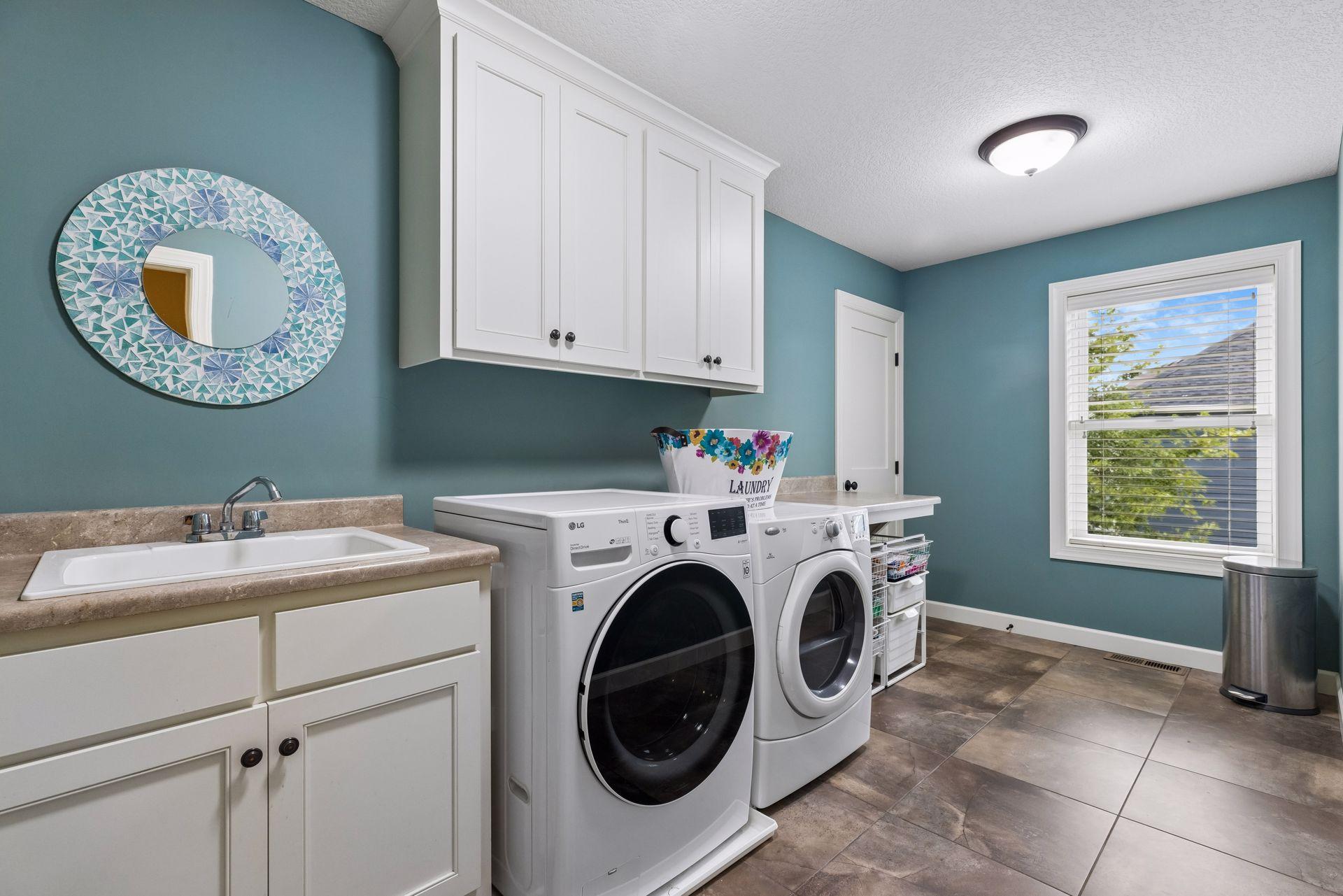 Upper level laundry with tub and tile floors