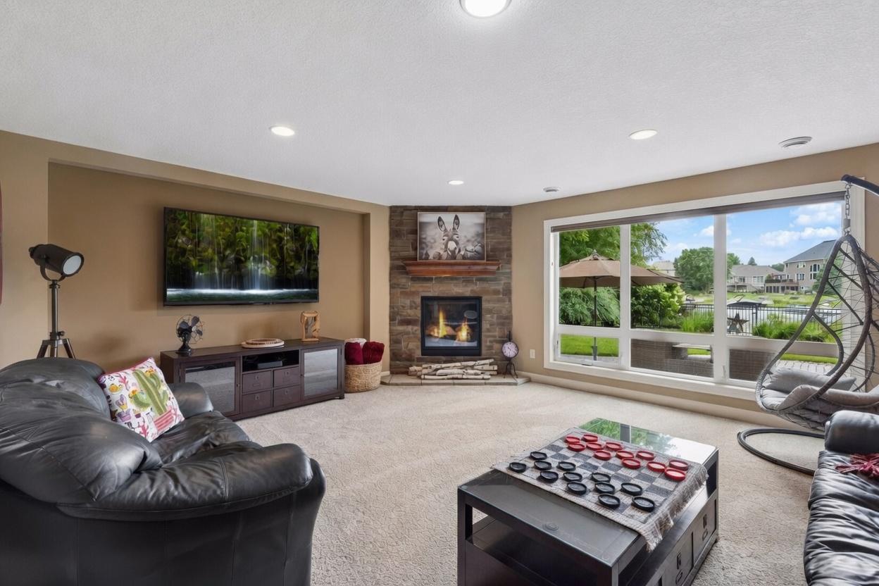 Lower level family room with gas fireplace and oversized operable windows