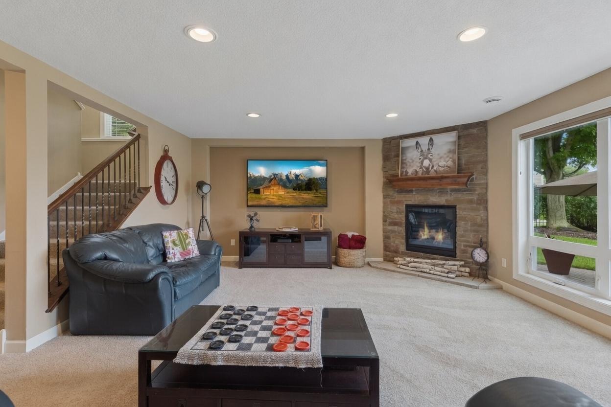 Lower level family room with gas fireplace and oversized operable windows
