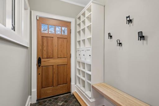 Large entry space with built in shelves and bench.