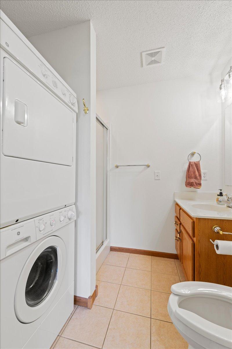 Primary suite bathroom including laundry