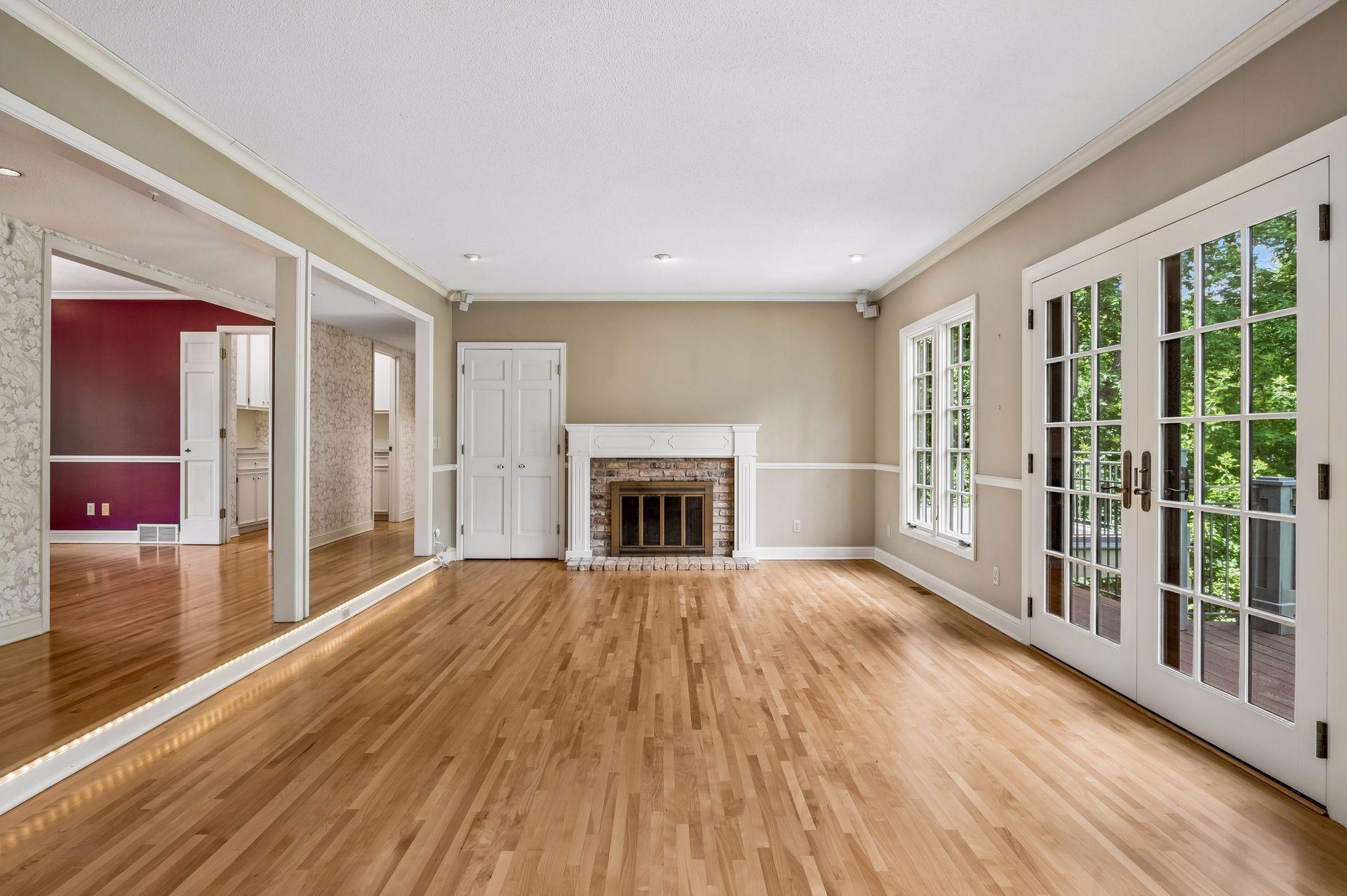 Large windows and french door out to deck overlooking private backyard