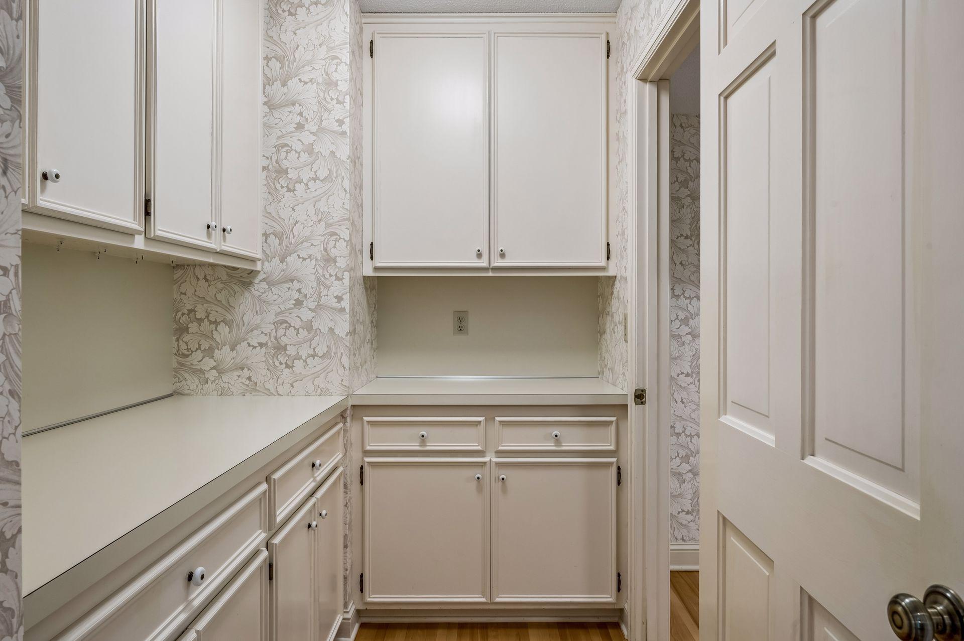 Butler's pantry with door to kitchen and french door into dining room