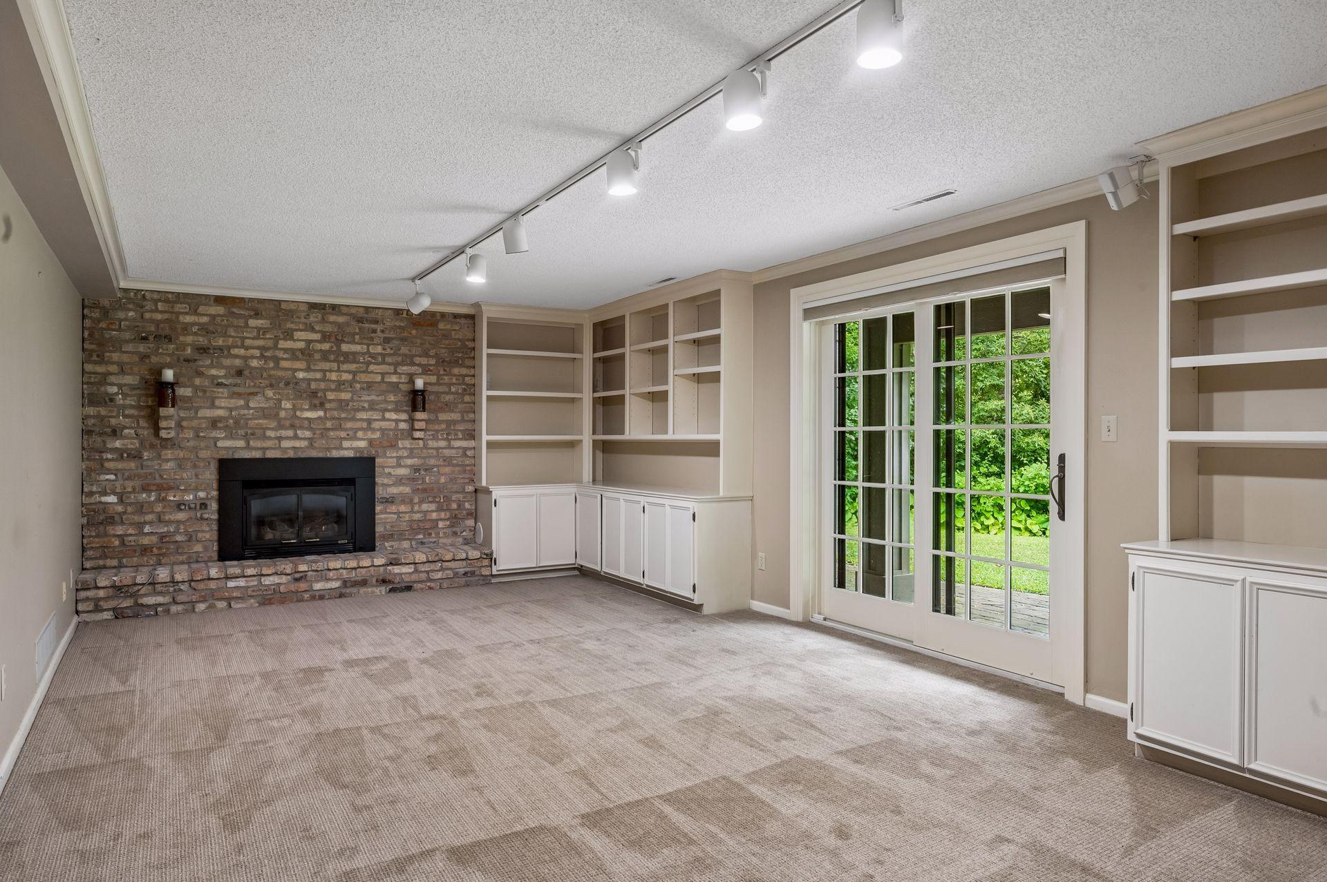 Large lower family room with gas fireplace, surround sound, walkout to patio and tons of storage
