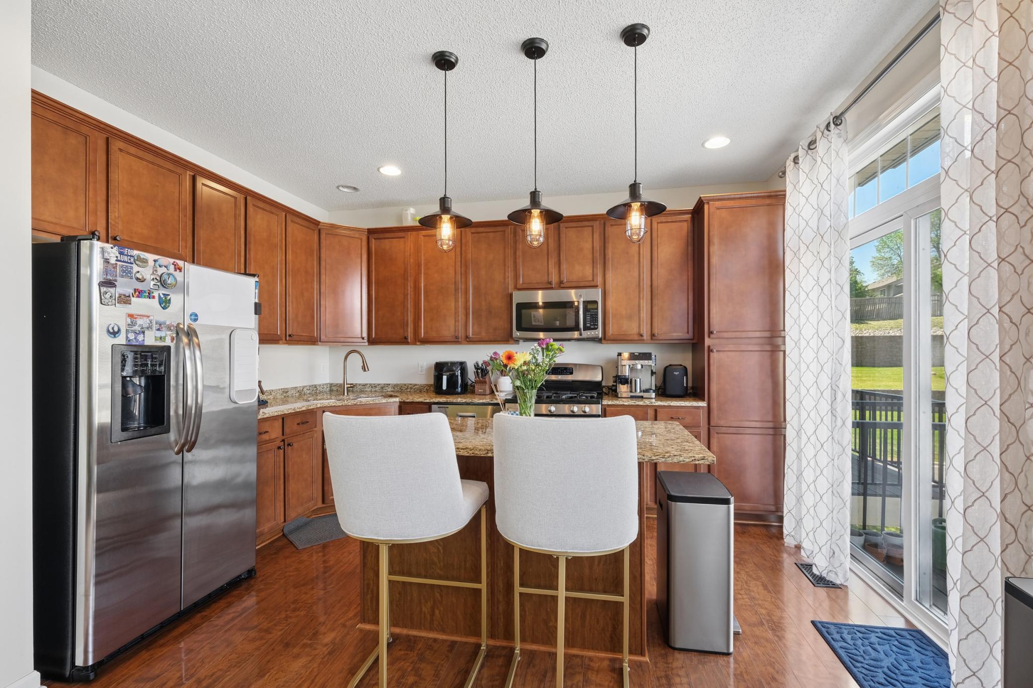 Beautifully updated kitchen with granite counters, cherrywood cabinets, and SS appliances