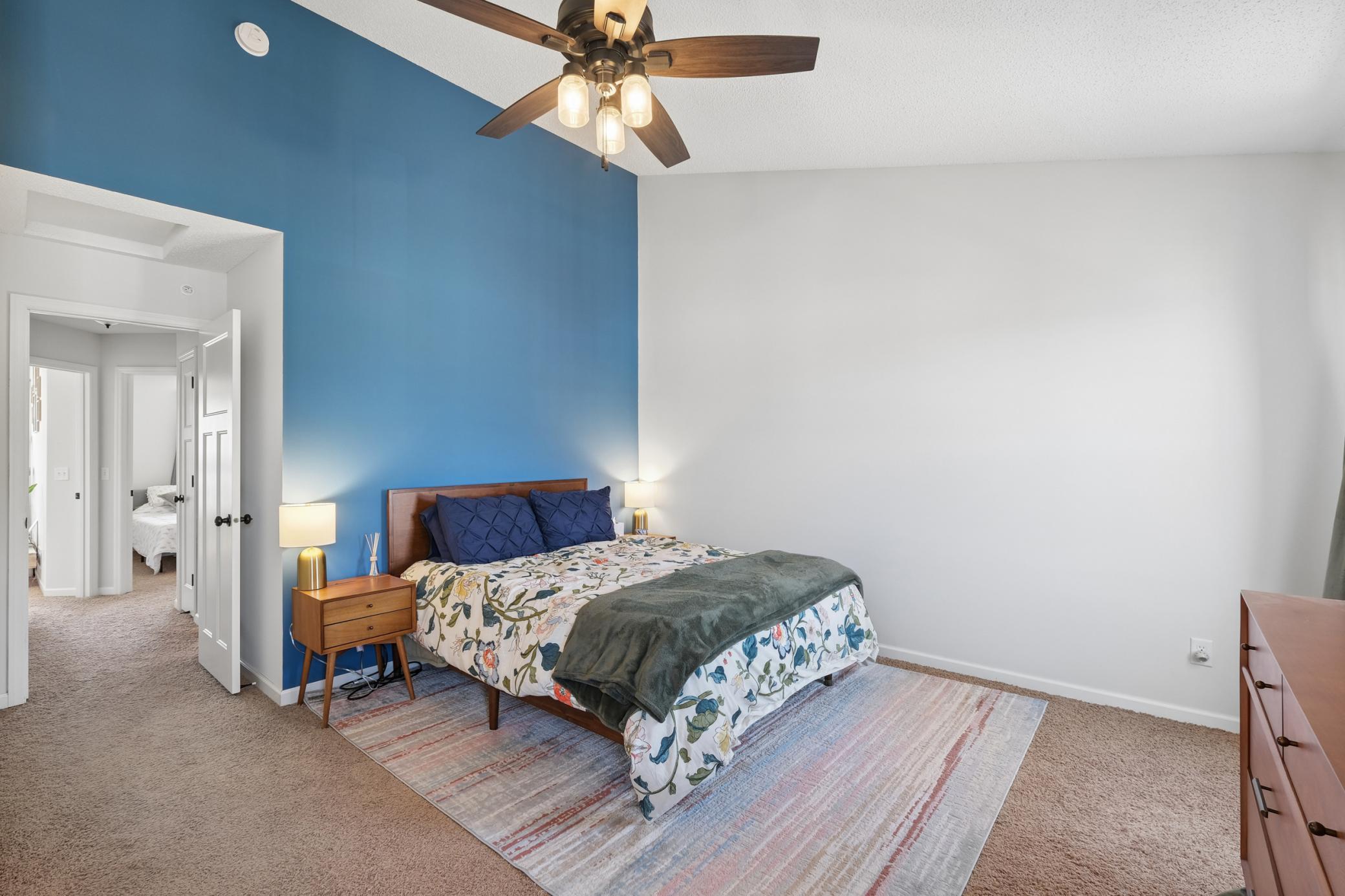 Oversized primary bedroom with vaulted ceilings