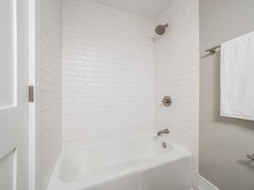 Beautiful custom tilework throughout the tub/shower surround adds timeless style and craftsmanship.