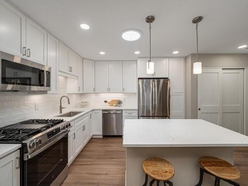 Every detail was carefully considered—from the quartz countertops and custom backsplash to the soft glow of under-cabinet lighting.
