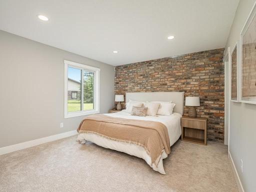 A stunning statement brick accent wall adds warmth and character to this primary bedroom, complemented by premium carpeting, recessed lighting, new Andersen window. The adjoining 3/4 primary bath completes this beautifully updated retreat.