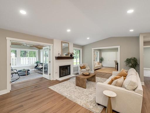 The living room features a cozy fireplace and opens to the 4-season sunroom, filled with abundant natural light from large windows. Sunrooms are a sought-after feature that buyers love in these townhomes.