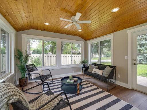 A bright and inviting sunroom refreshed with new trim and luxury vinyl plank flooring—the perfect spot to relax and enjoy the natural light.