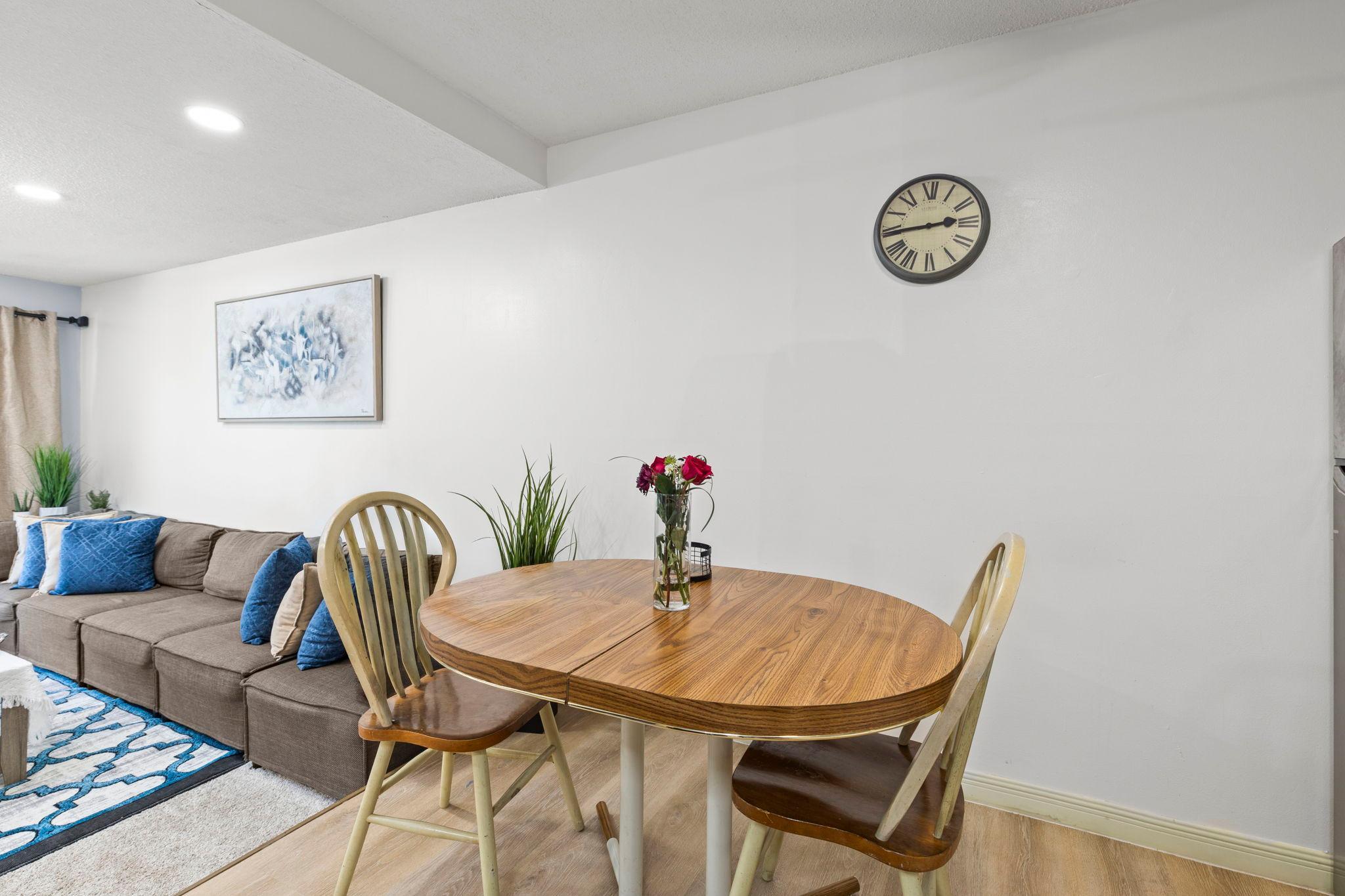 The dining space is perfect for sharing meals and features a ceiling fan for added comfort.