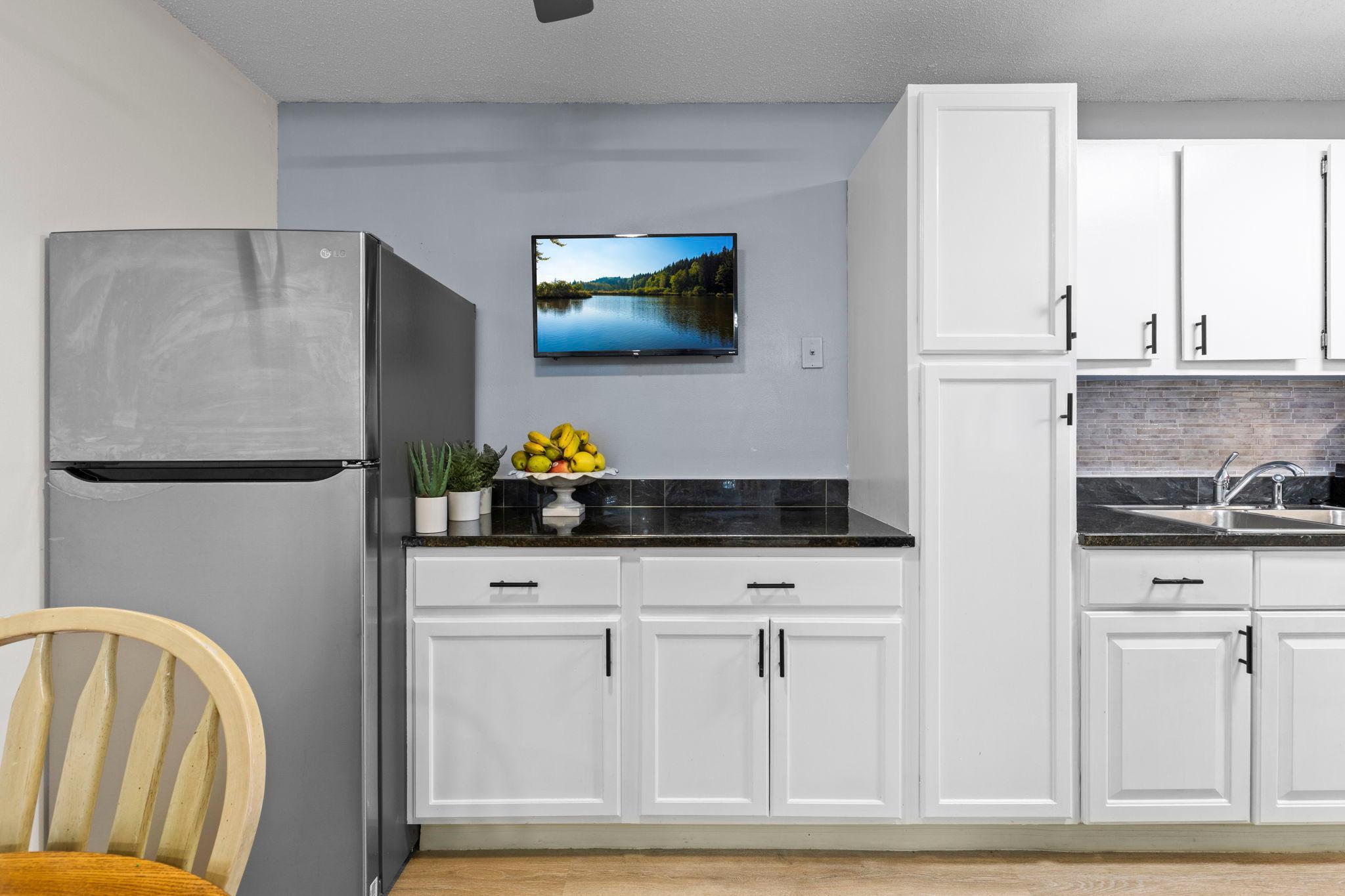 Another view of the kitchen highlights the seamless flow into the dining area, providing additional counter space and creating a functional space for entertaining.