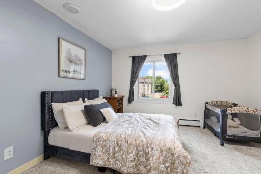 The spacious bedroom offers dual closets and carpeting.