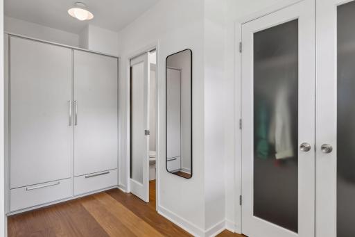 Large mudroom, with coat closet and storage closet with power outlet to charge vacuums and more.