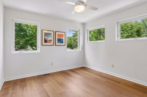 Third of three bedrooms upstairs, also with Brazilian Teak engineered hardwood, and filled with windows.