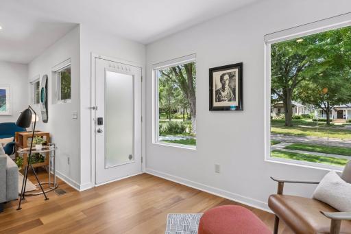 Front entry with frosted glass door, and large windows.