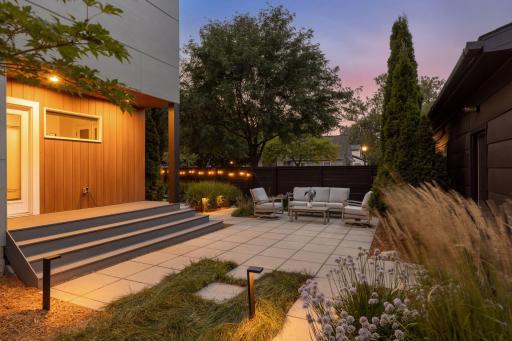 Hardwired landscape lighting highlights the professional landscaping by Landscape Love.