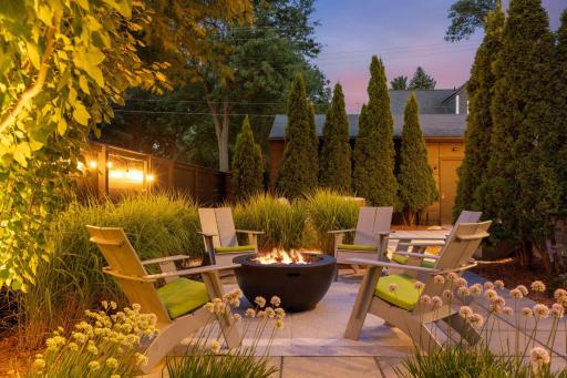 Backyard firepit, currently propane fuel, with gas lines positioned underneath for future gas fire pit connection.