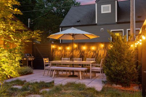 The dining area is one of three separate seating areas in the beautifully landscaped backyard.