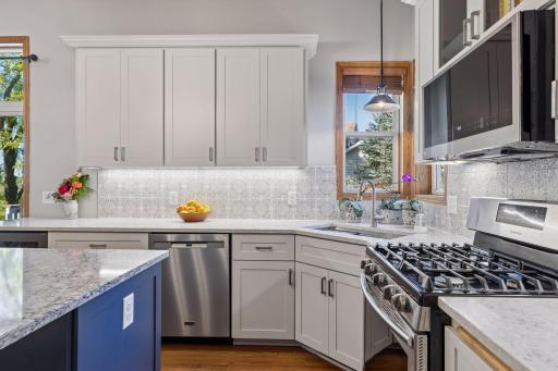 Gorgeous kitchen cabinets, pulls, counters, backsplash, and lights. It is perfect.