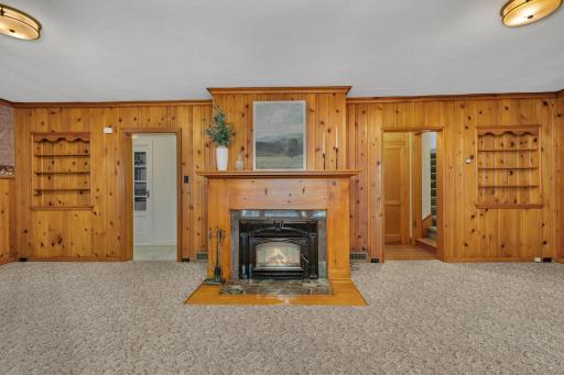 Charming wood burning fireplace with updated insert in the living/dining room of the home.