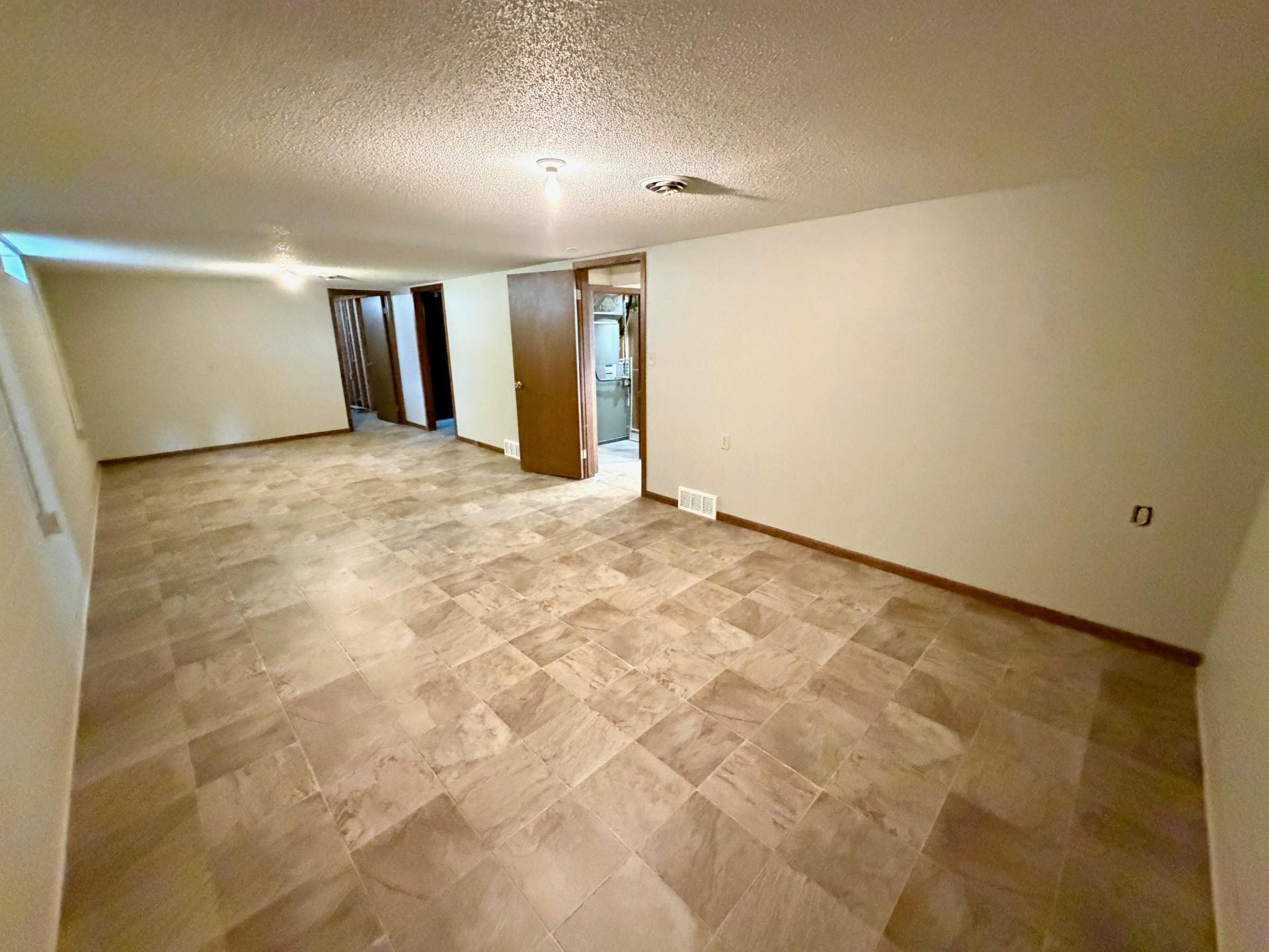 lower level recreation room with fresh paint and new flooring.jpg
