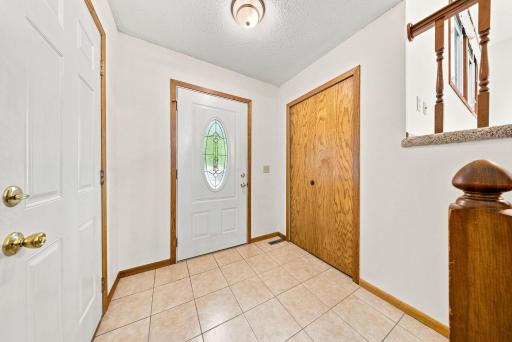 Welcoming front entry with convenient coat closet and durable tile flooring.