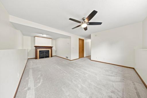 Cozy gas fireplace creates a warm focal point, making this large family room perfect year-round.