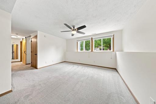 Bright and inviting lower-level living area features oversized windows and flexible space to fit your lifestyle.