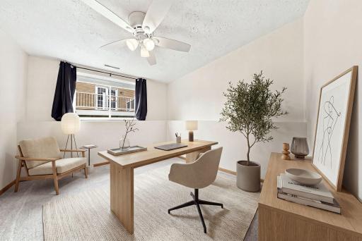 Virtually staged to highlight the perfect work-from-home office, complete with room for both productivity and relaxation.