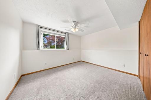 Another generously sized lower-level bedroom offers flexibility for family, guests, or a dedicated workspace.