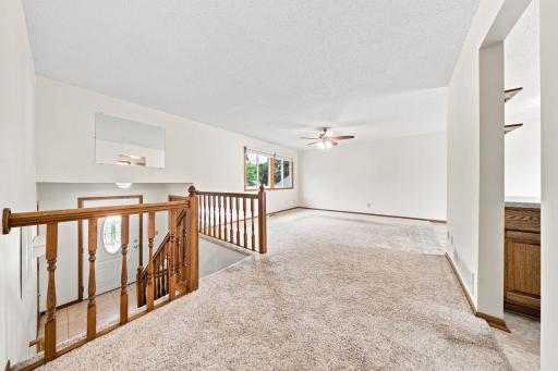 Spacious living room filled with natural light and overlooking the front yard.