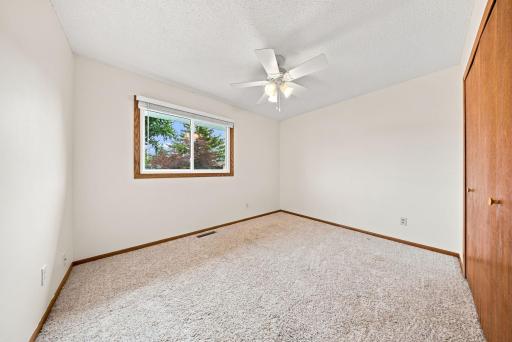 Second main-level bedroom with generous closet space and bright window.