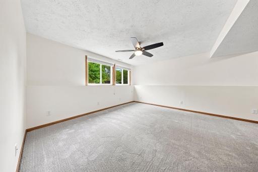 Expansive lower-level family room offers endless possibilities for movie nights, game days, a home gym, or play space, all with brand-new carpet and abundant natural light.