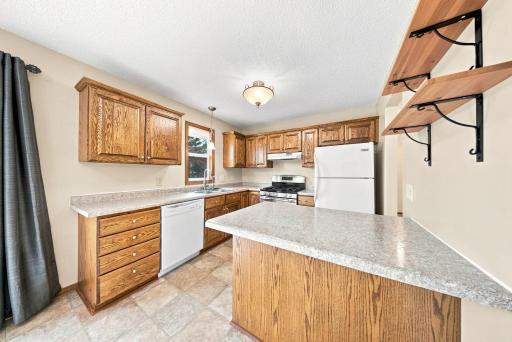 Functional kitchen featuring abundant cabinet space, center island, and breakfast bar