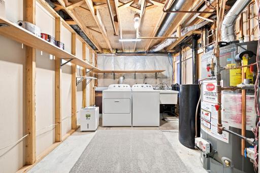 Generous utility and laundry area provides excellent storage, workspace, and easy access to the home's mechanical systems.