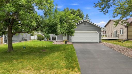 Beautifully maintained exterior features updated landscaping, mature trees, and a welcoming front entry.