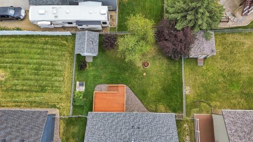 Top-down aerial view emphasizes the expansive fenced yard with room to play, garden, or entertain.