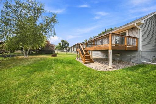 Large maintenance-friendly deck overlooks the fenced backyard, creating the perfect space for grilling and outdoor gatherings.
