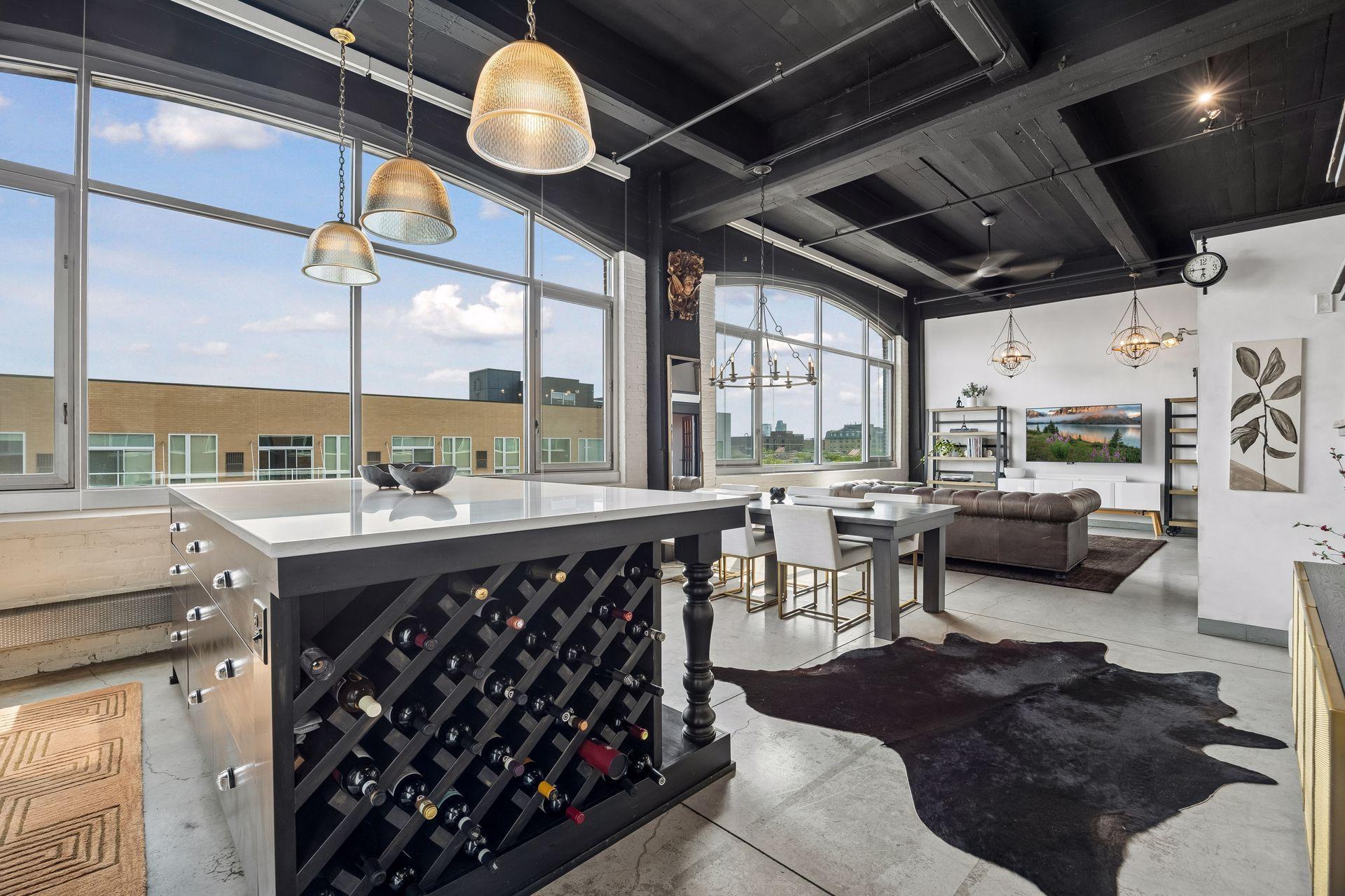 Soaring ceilings and concrete floors create a sense of volume, grounding the home in its industrial roots.