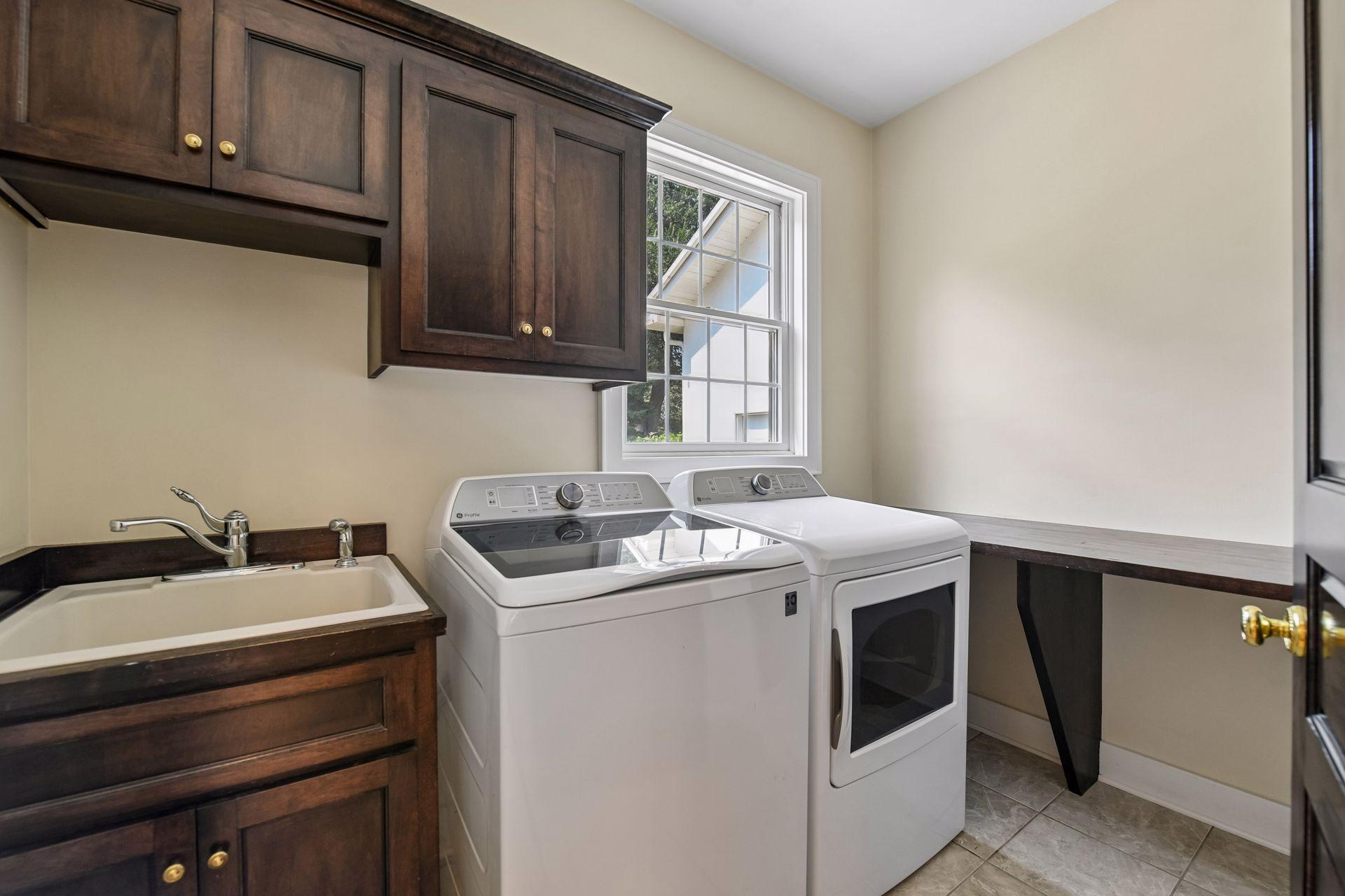 Crisp and clean - the Laundry features tiled floors, built-in cabinetry and a folding counter.