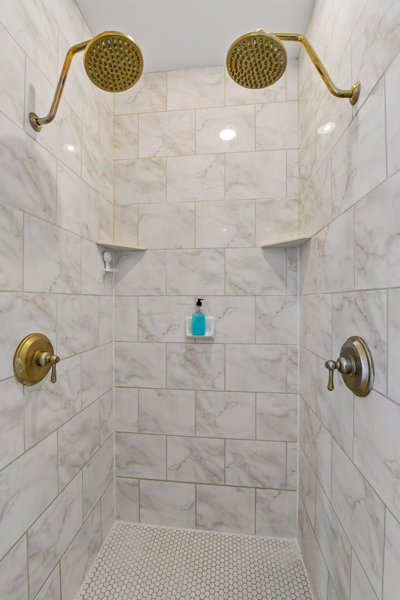A tiled, walk-in shower with dual shower heads completes the Primary Bath.