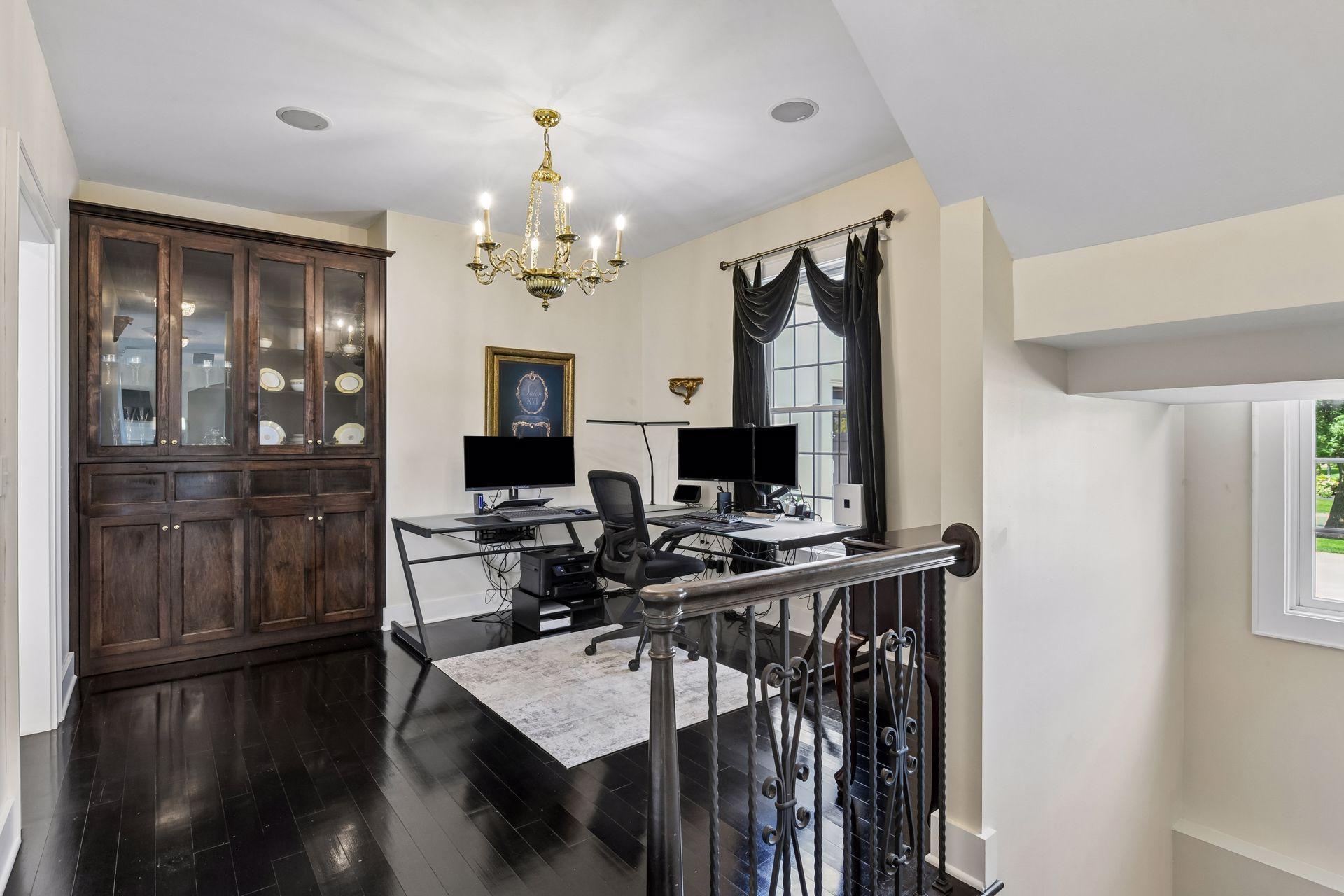 The Formal Dining Room is currently used as a Home Office. The built-in cabinetry features a hidden pull out bar.