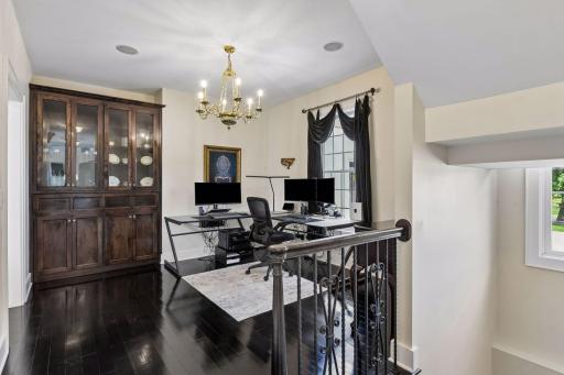 The Formal Dining Room is currently used as a Home Office. The built-in cabinetry features a hidden pull out bar.